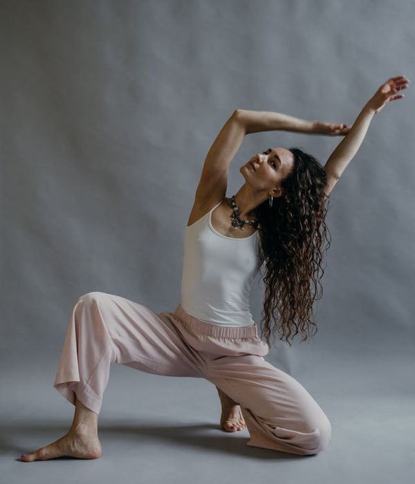 Person in a calm, flowing pose, demonstrating flexibility and balance.